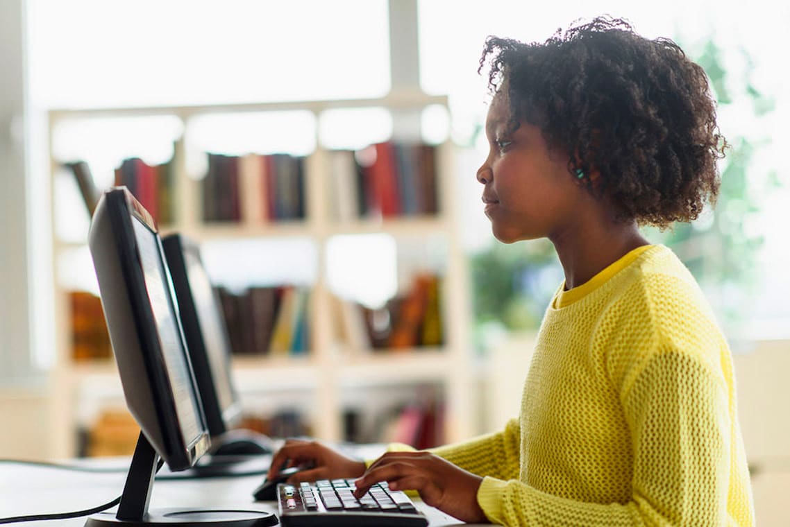 Student working on computer in library